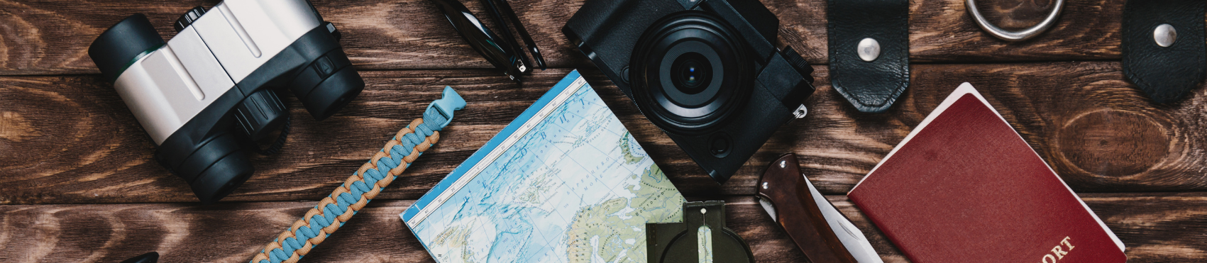 Photo of tourism items: Map, Camera, Passport, Binoculars 