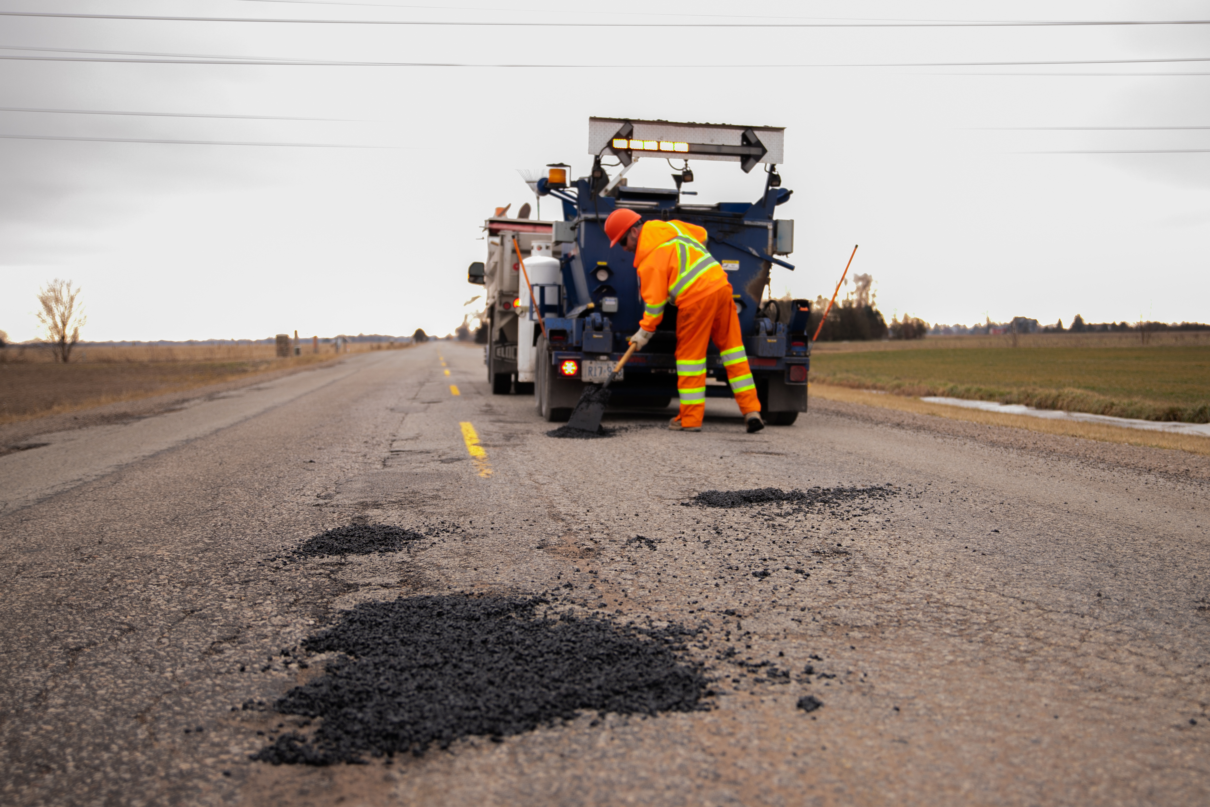 Lakeshore staff member filling a pothole. 