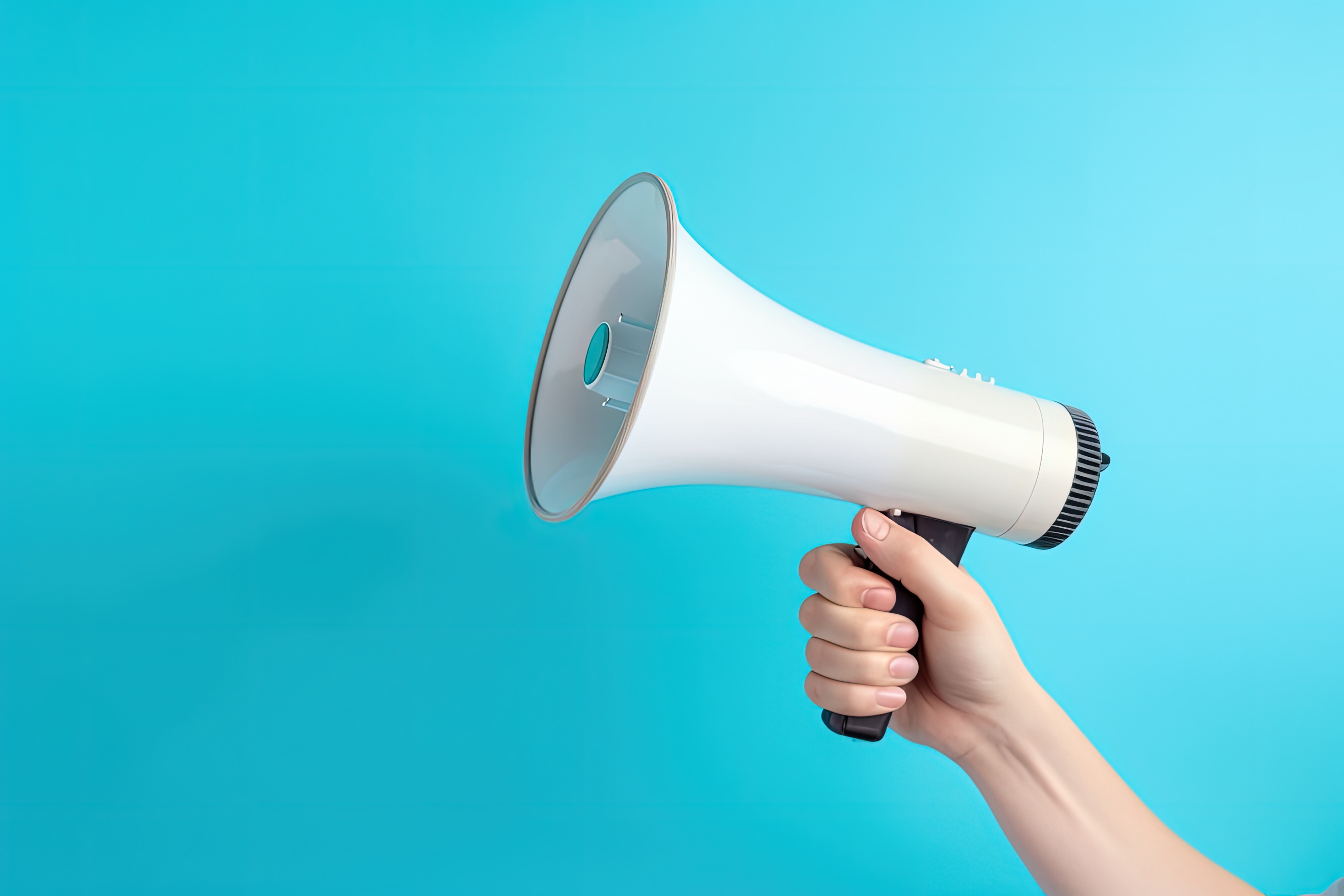 Hand holding a megaphone on a light blue background.