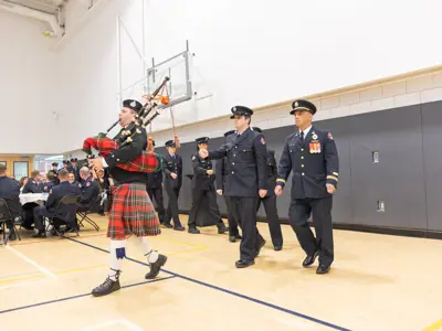 recruits being bagpiped in