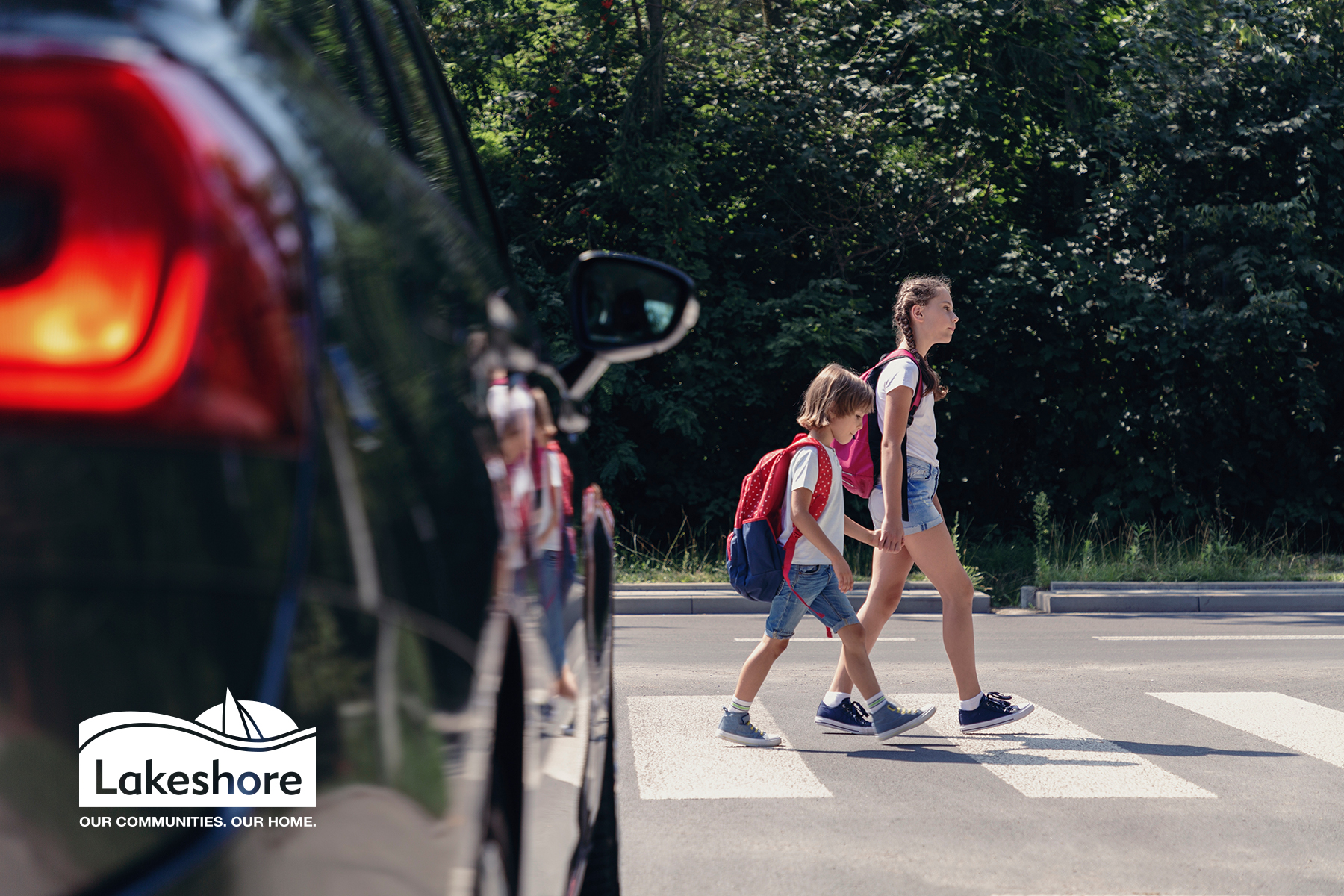 Two kids walking to school at a crosswalk