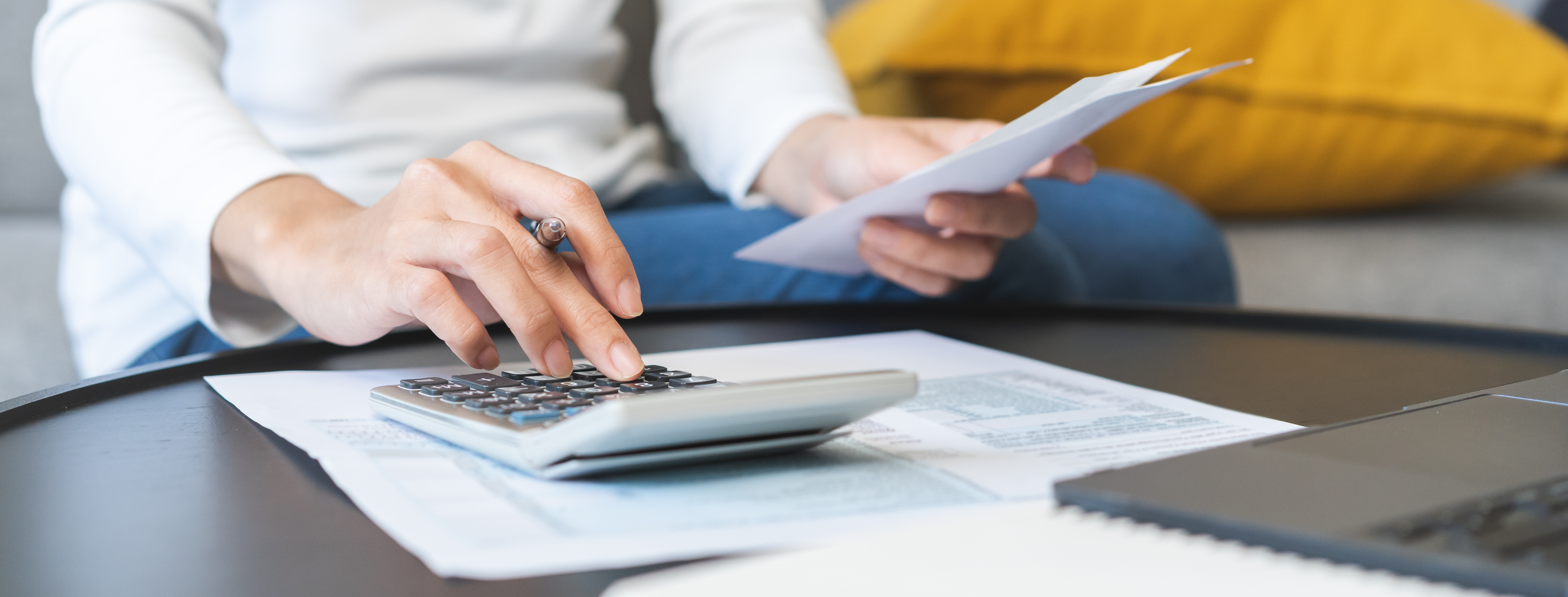 Person with calculator and documents